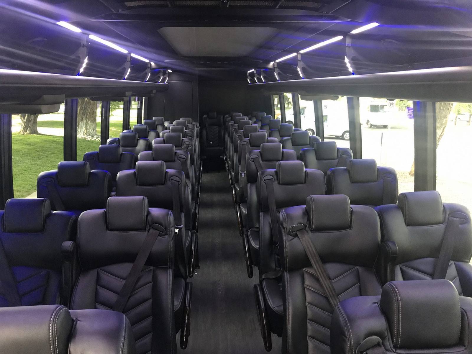 Interior view of a luxury motor coach with rows of black leather seats
