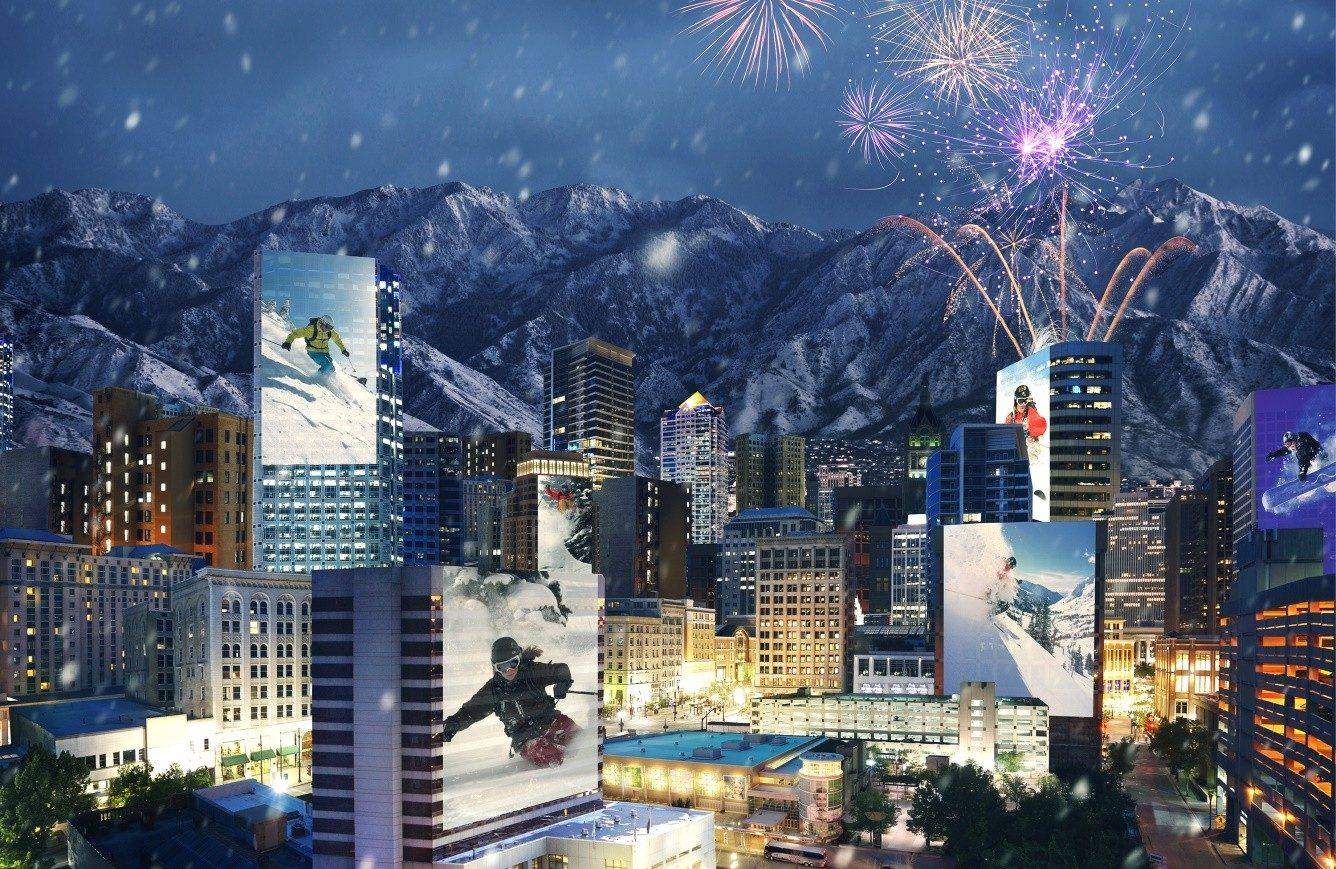 Salt Lake City skyline at night with fireworks and winter sports imagery celebrating the 2034 Winter Olympics