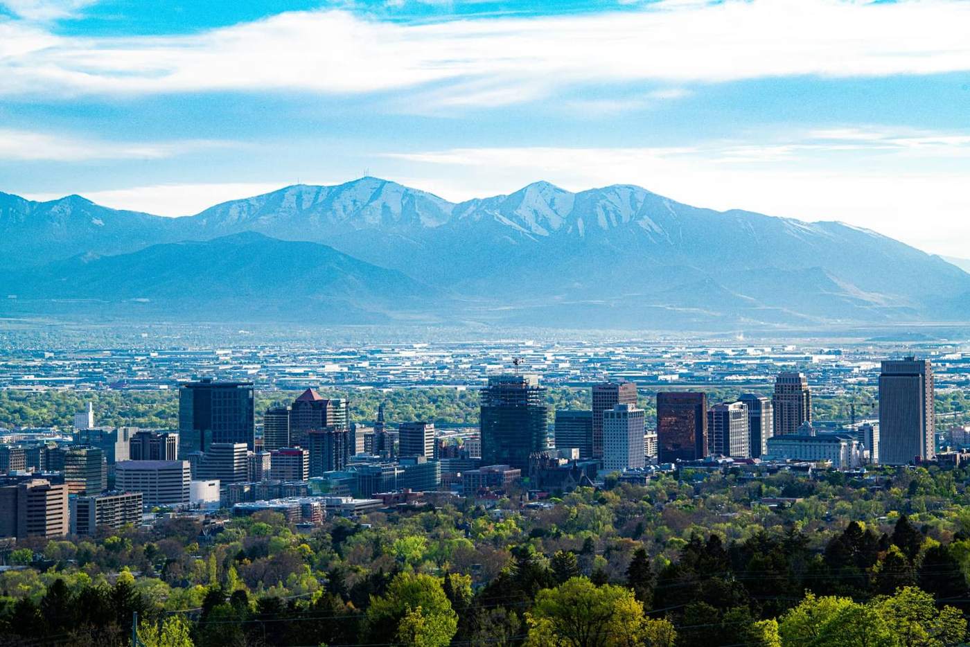 Salt Lake City skyline with the Wasatch Mountains behind it on a bright day